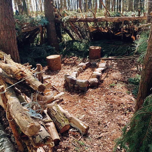 Survival-Lager mit Feuerstelle im Wald.