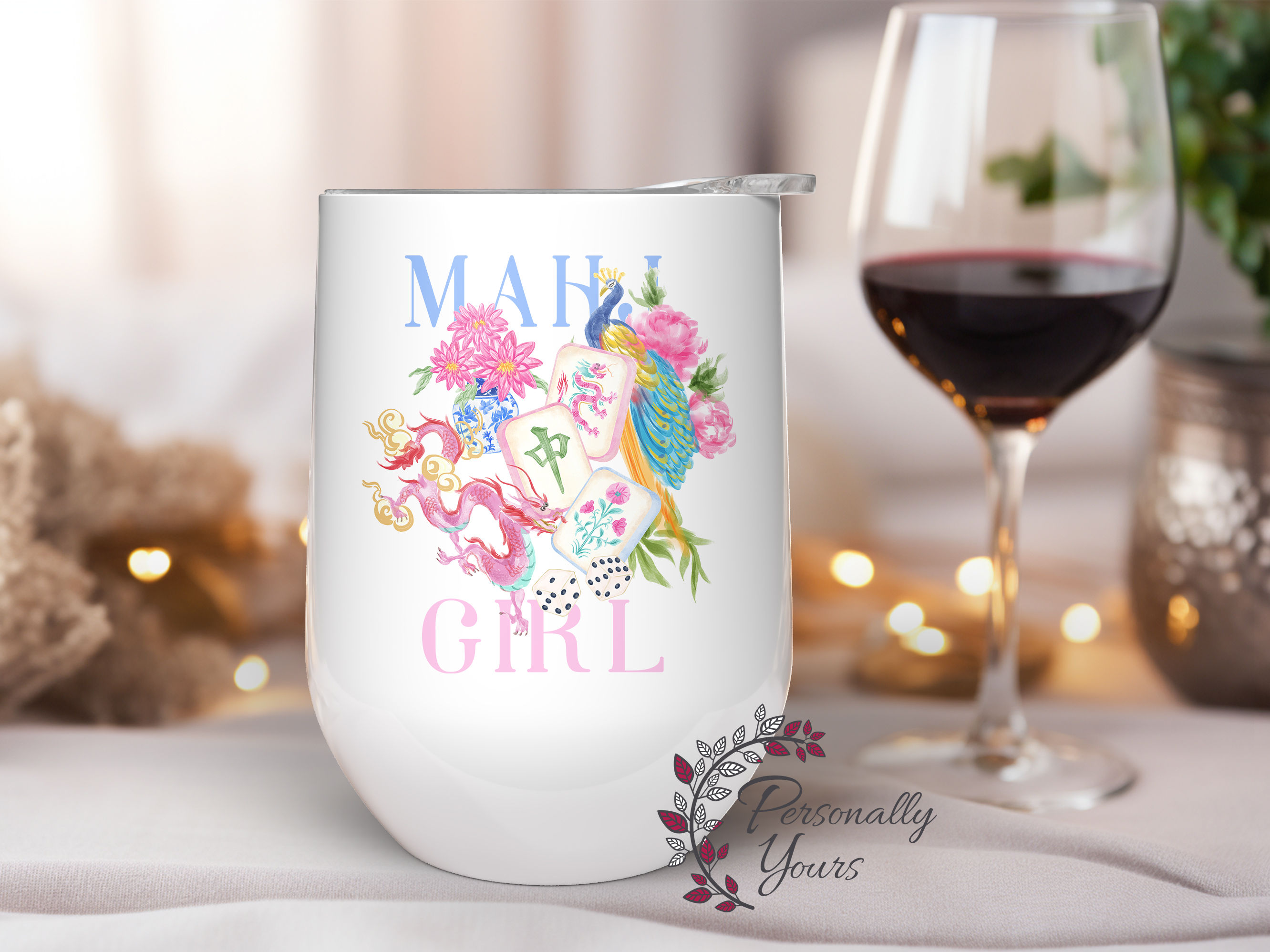 Mahj Girl stemless wine tumbler with colorful Mahjong tiles, floral accents, and peacock design on a white insulated cup