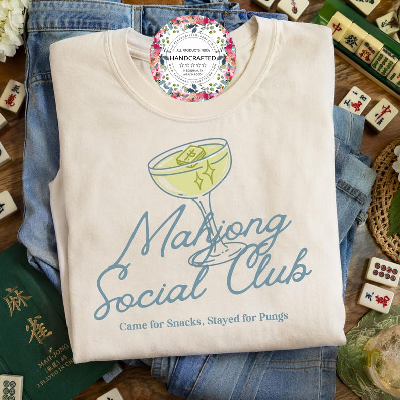 Mahjong Social Club neutral shirt styled with Mahjong tiles and denim flat lay