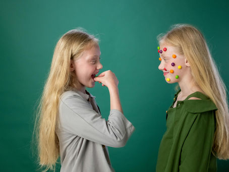 Two girls having fun with candy