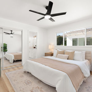 a bedroom with a Cal King bed and a ceiling fan