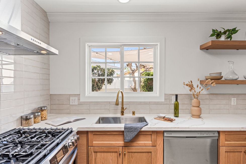 white oak modern kitchen with stainless steel appliances 