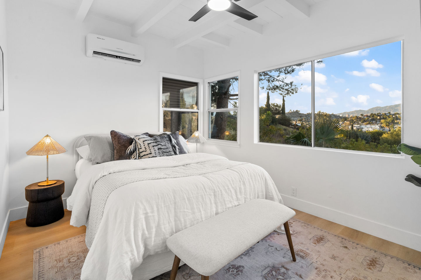 a bedroom with a queen size bed and a ceiling fan