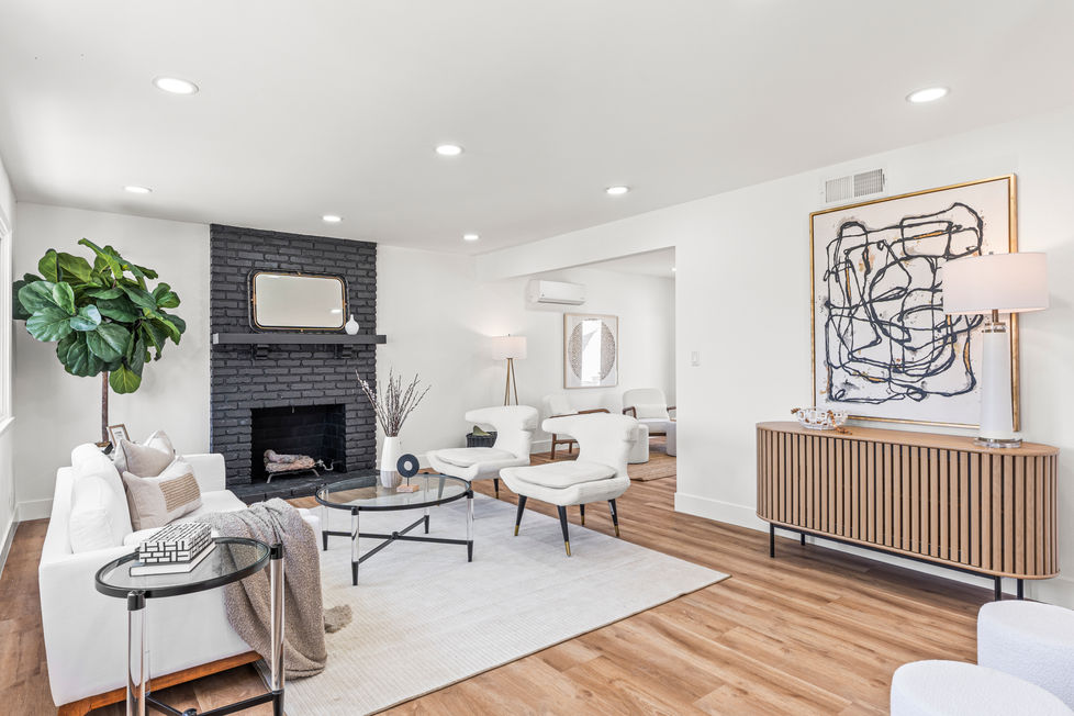 a living room with organic modern furniture and a cozy fireplace