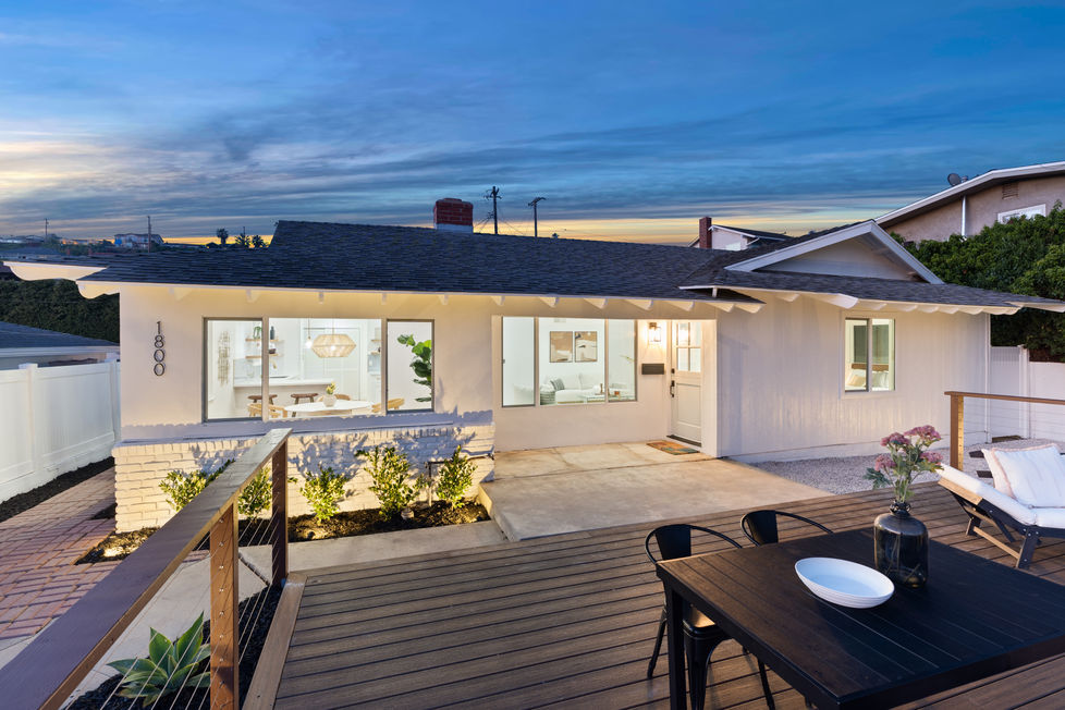 a white house with a composite deck in front of it