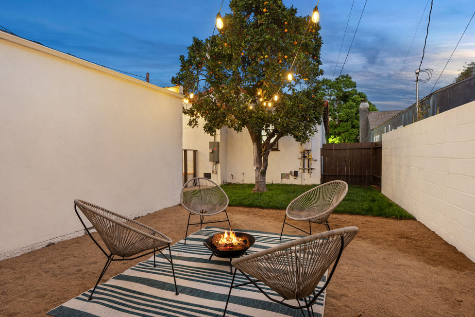 a patio area with chairs and a fire pit