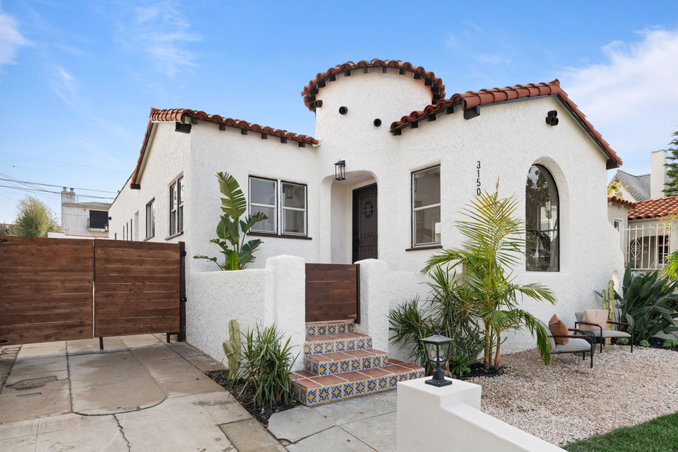 Spanish modern white house with a terracotta tile roof and Spanish front porch tiles