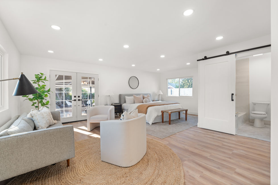 primary suite with a sliding barn door for primary. bathroom