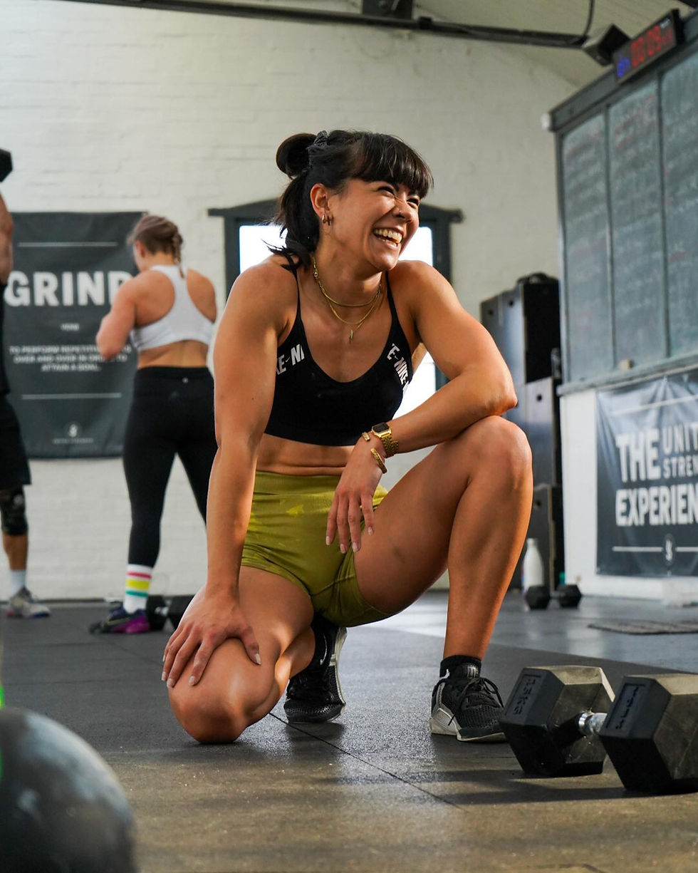 Happy lady being photographed laughing in a gym environment