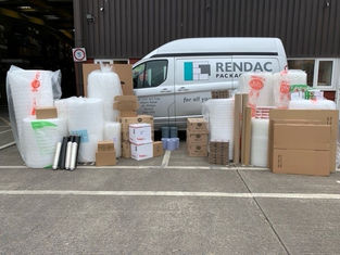 Company van with packaging materials place in front of it