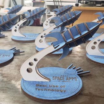 A collection of laser cut rocket-shaped trophies.