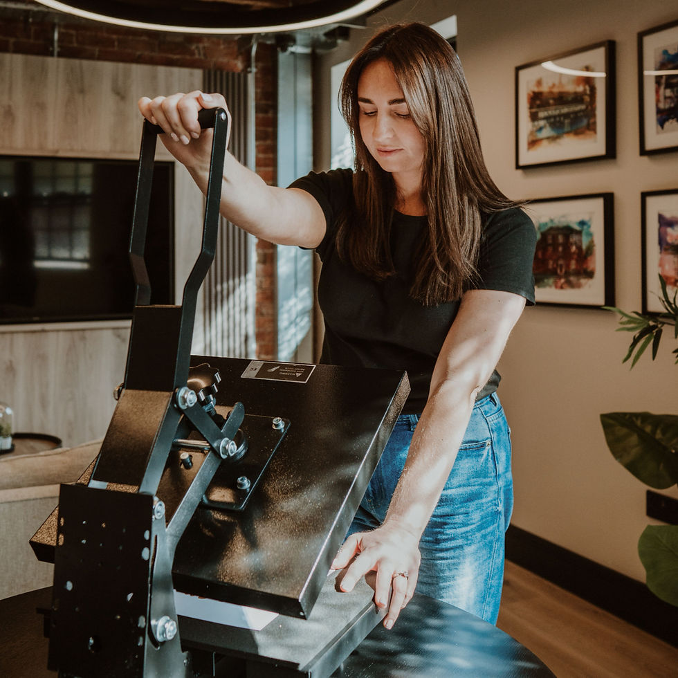 Ashley Eccleston operating a foil printing machine at Bespoke Foil Company studio