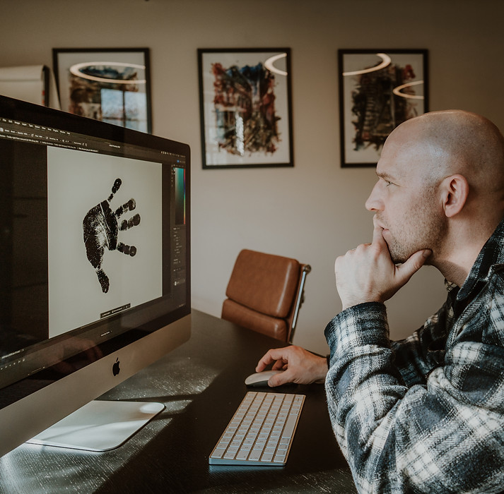 Ryan Eccleston designing personalised foil print artwork on a computer
