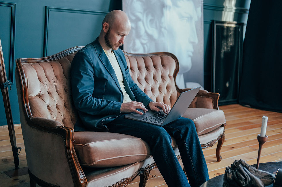attractive-adult-successful-surprised-bald-man-with-beard-suit-working-laptop.jpg