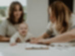 Smiling family sitting together, with children looking at a framed foil keepsake print