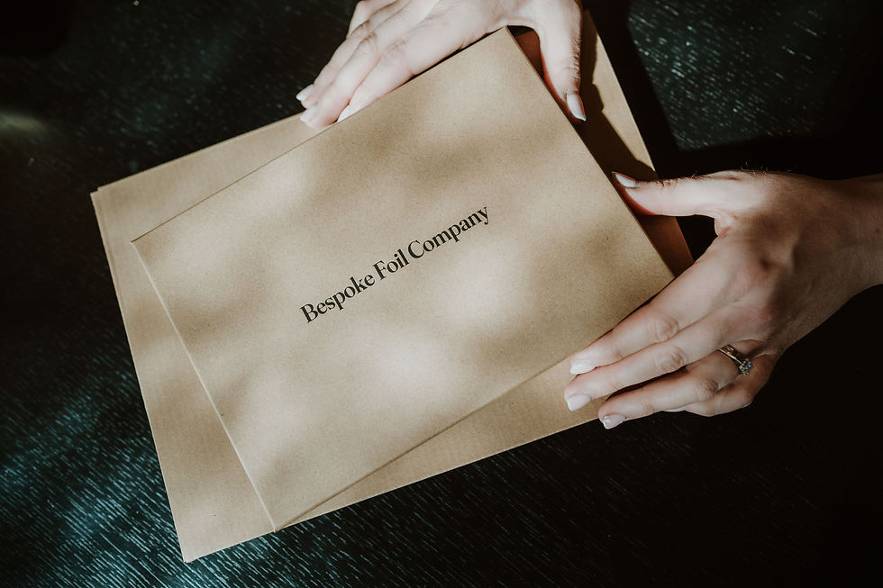 Hands holding eco-friendly Bespoke Foil Company Hand and Footprint Kit Keepsake Box