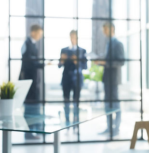 blurred-image-business-people-standing-office.jpg