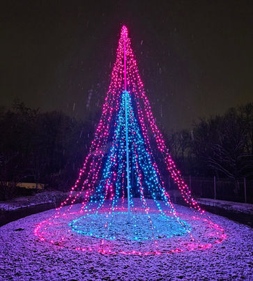 A colorful light display with pink and blue lights arranged in a cone shape on a snowy ground. Holiday lights near me.