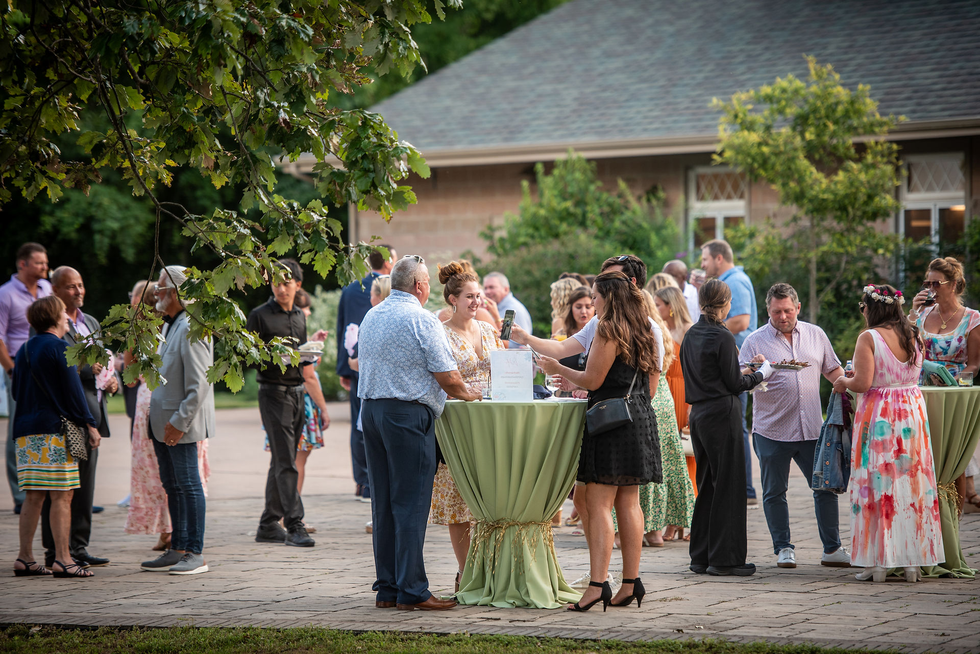 guests socializing near tables on the Event Plaza