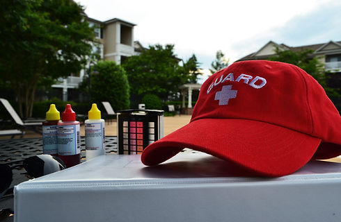 Lifeguard hat lying on a pool book near the chemical control liquids close up photo.jpg