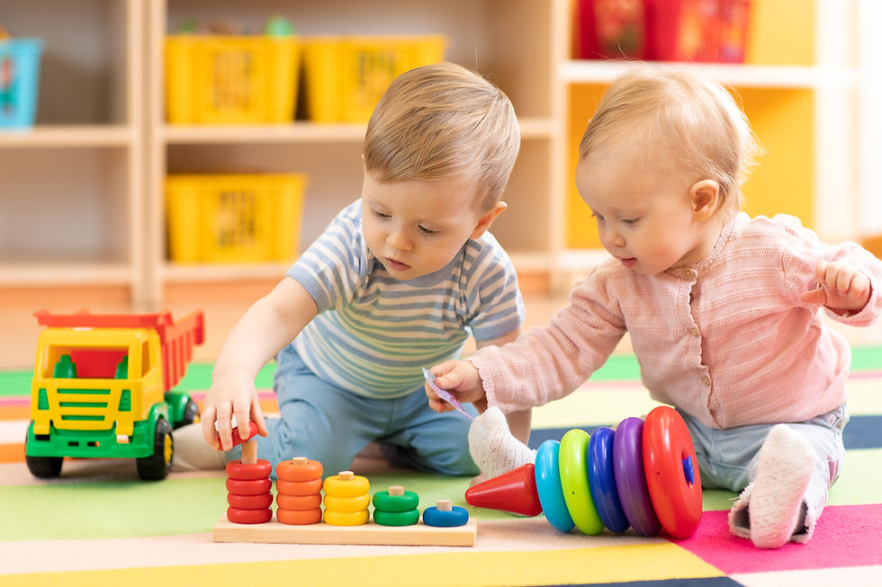 Preschool boy and girl playing on floor with educational toys. Children toddlers at home o