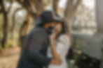 Country couple leans up against a John Deere for engagement photos