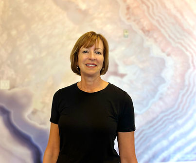 nancy in black in front of rose quartz wall