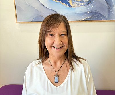 Portrait of Alanna Silato, energy healing practitioner at SYNC Therapies, photographed in a calm, softly lit setting.