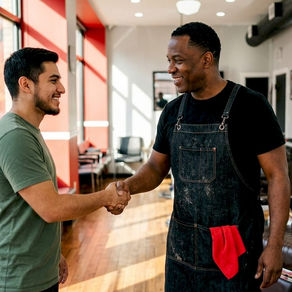 Barber welcoming returning client at shop entrance