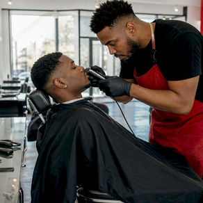 Man receiving gentleman's fade haircut at barbershop