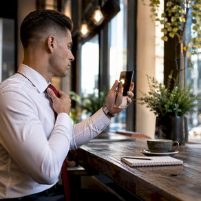 Young professional man adjusting tie with clean haircut