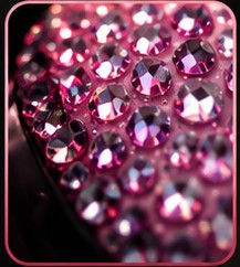 Detail of rhinestone jeweled motorcycle helmets in pink.