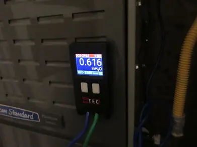 HVAC technician testing airflow and static pressure during AC diagnostic in Austin TX