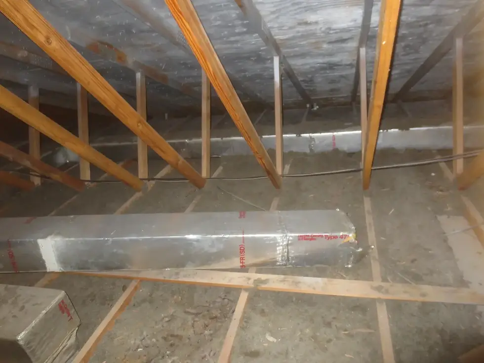 Low attic insulation with visible ceiling joists in Austin home