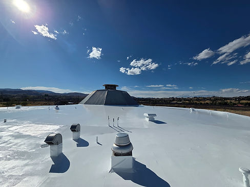 Finished glossy white coating on a commercial flat roof