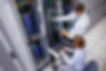 team-of-technicians-using-digital-cable-analyser-on-servers.jpg
