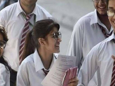 Nagaland Board of School Education NBSE 2026 exam schedule notification displayed on a laptop screen with a calendar and books in the background.