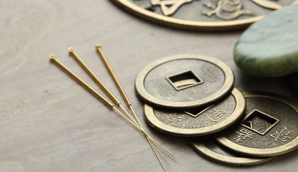 Acupuncture needles and ancient coins on beige marble table, closeup.jpg