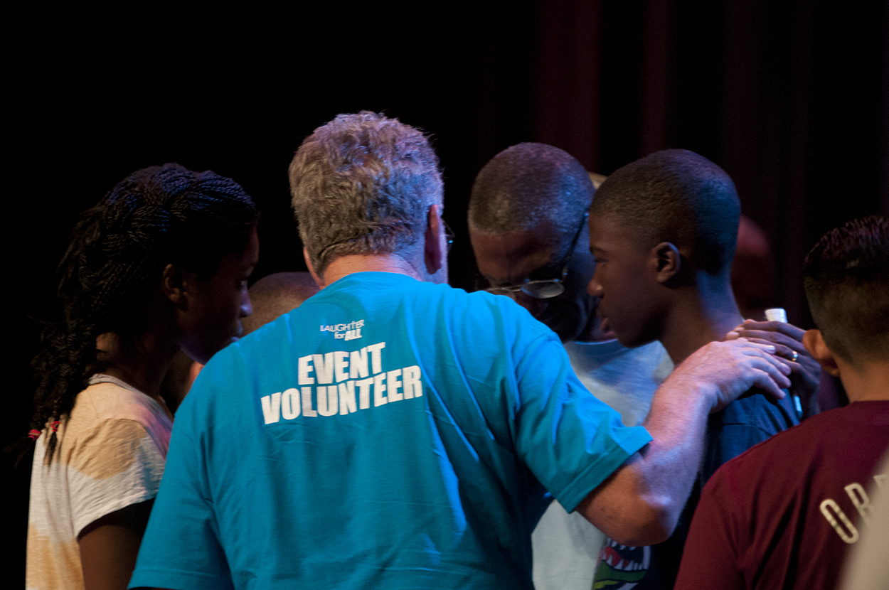 Event volunteer comforting attendees