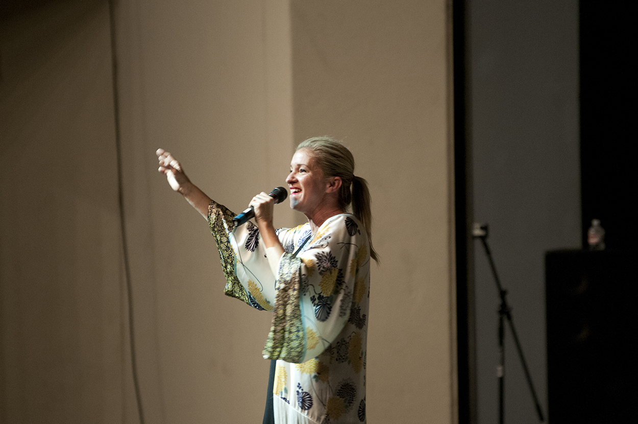 Singer performing on stage, microphone in hand