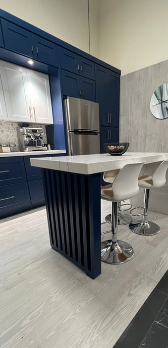 Modern kitchen with navy blue cabinets and island.