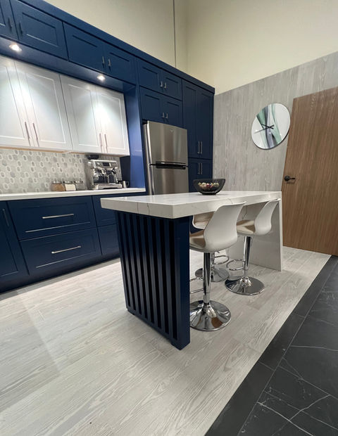 Modern kitchen with navy blue cabinets and island.