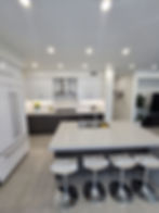 Modern kitchen design with white cabinetry and island seating. General Contractor OC.