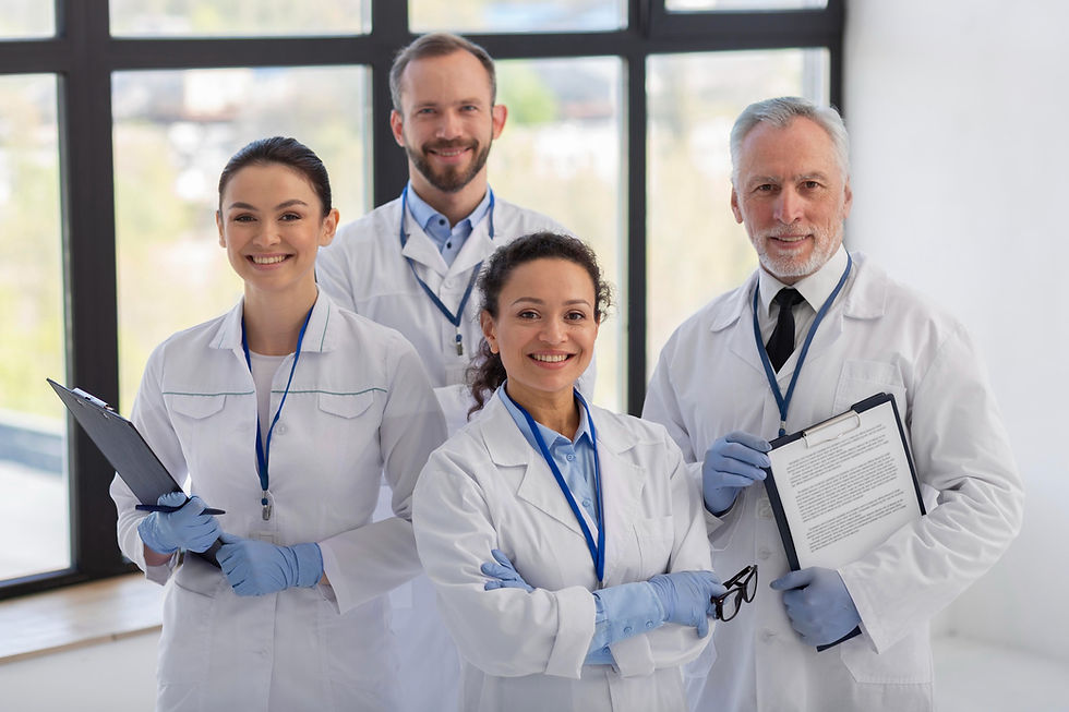 Smiling team of professionals in lab coats