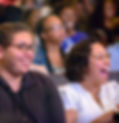 Happy audience members enjoying Laughter For All