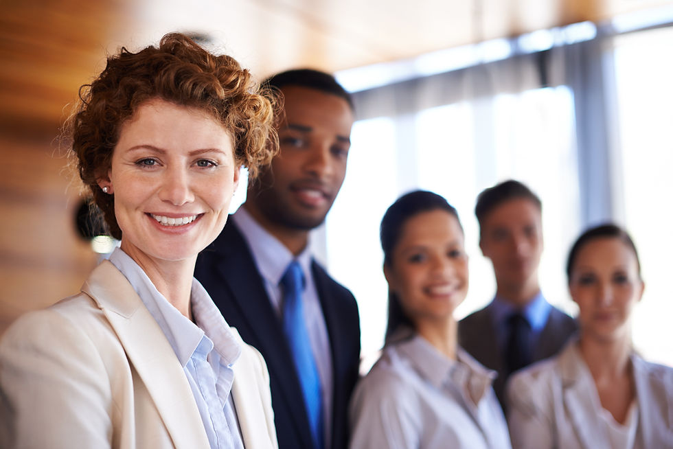 Four diverse business professionals smiling