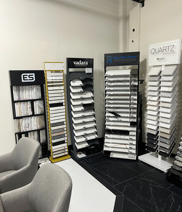 Various stone samples on display in a showroom setting for remodeling projects.