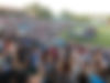 Large crowd applauds at outdoor event