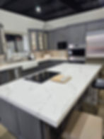 Modern kitchen design with white countertop island and built-in appliances