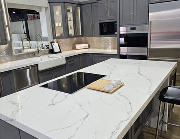 Modern kitchen with white countertop, cabinets, appliances, and Kitchen Remodeling design.